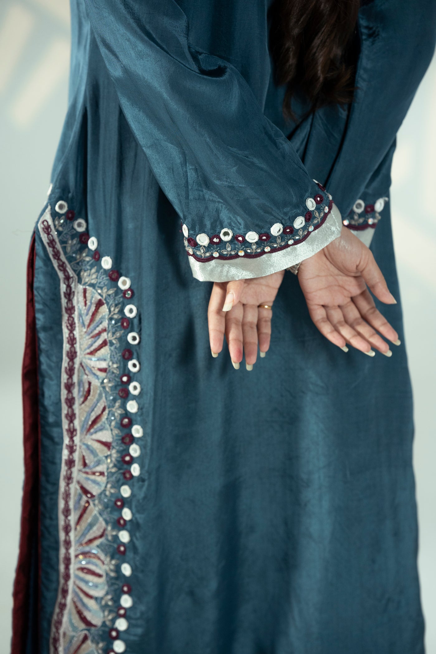 Elegant 'Zari two-piece kameez with matching trousers, featuring luxurious mirror work and cutdana details.